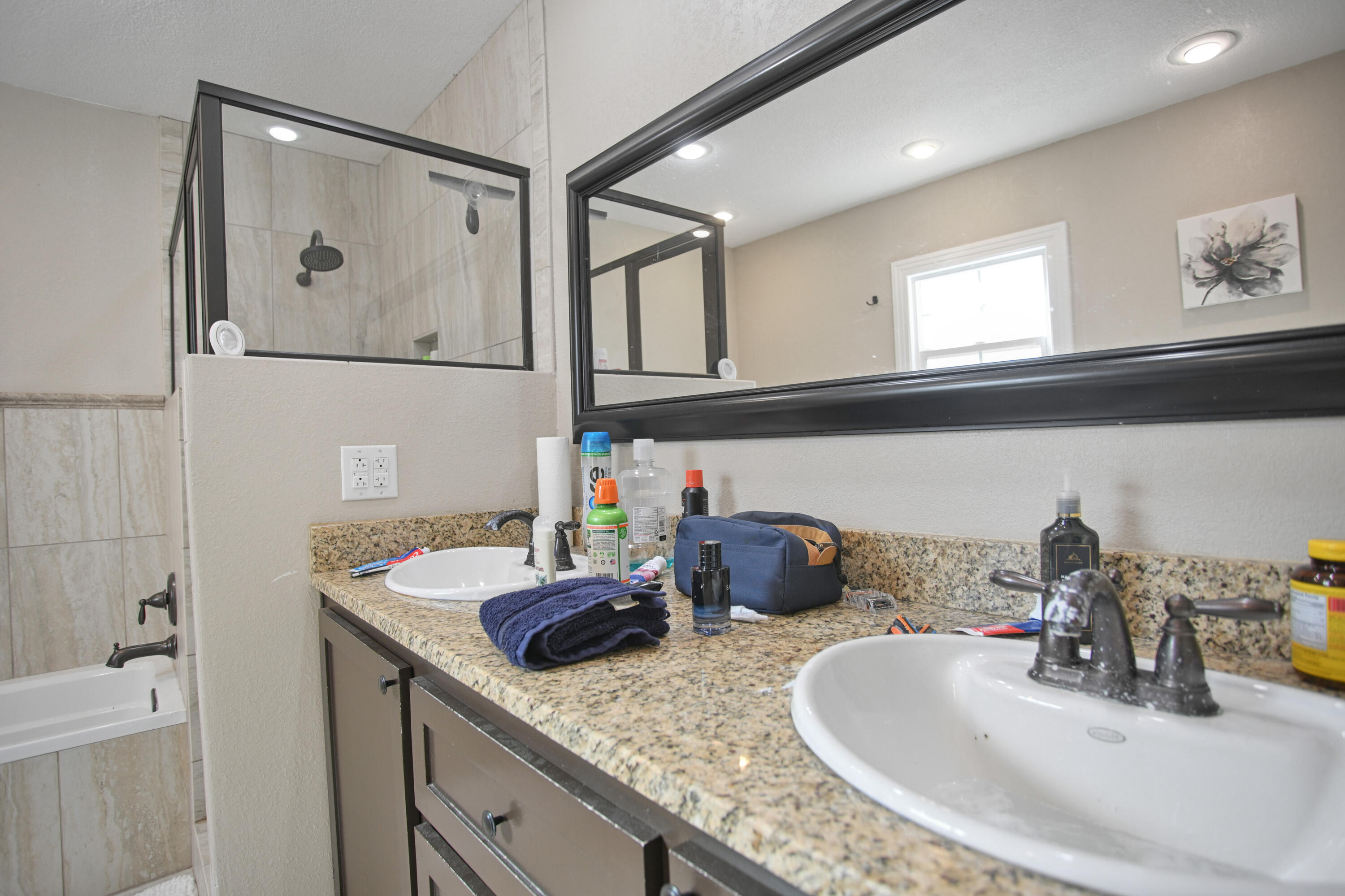 3013 28th Street Lubbock, TX 79410 - Photo 26 of 38 a bathroom with a double vanity sink and a mirror