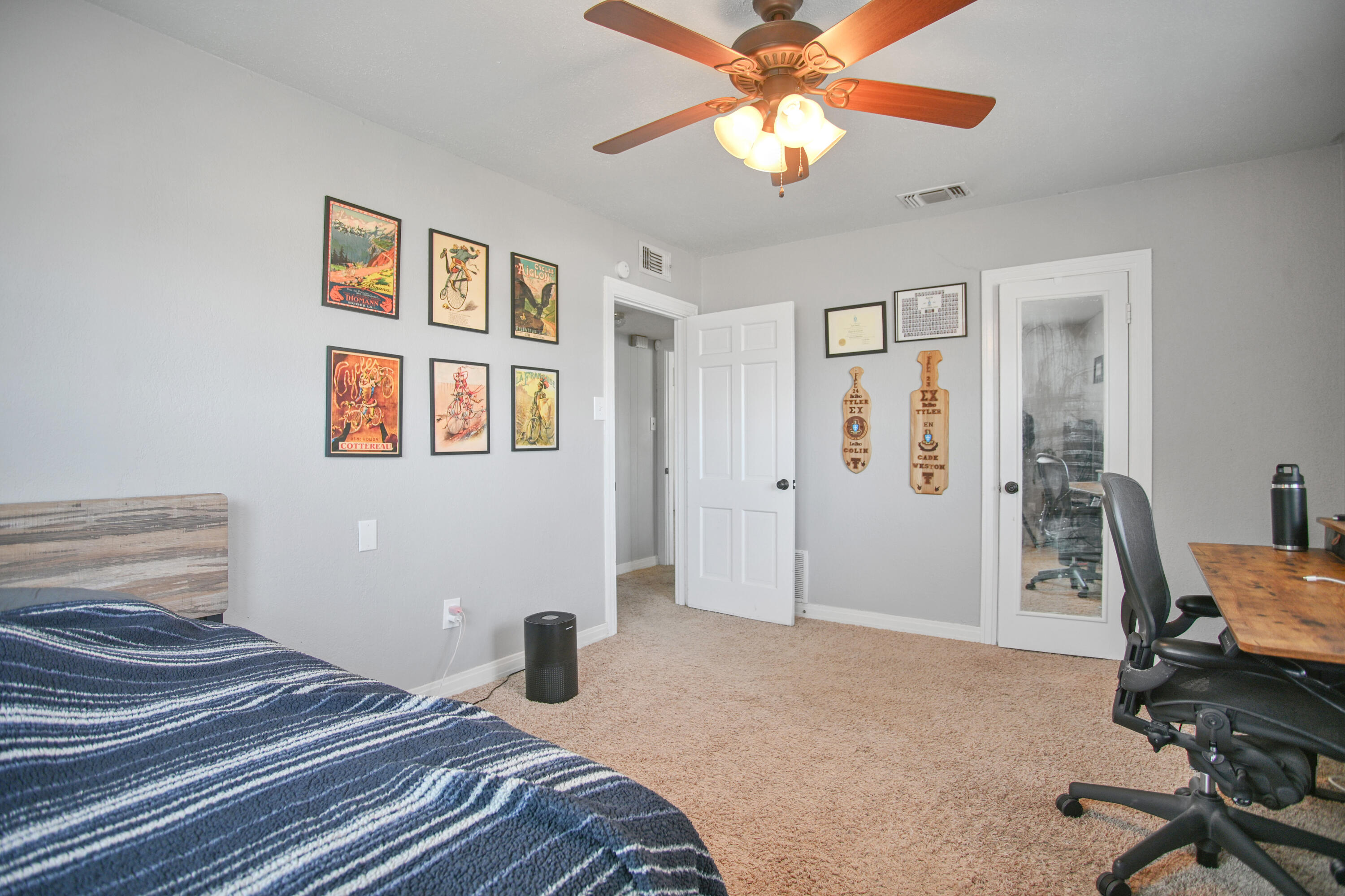 3013 28th Street Lubbock, TX 79410 - Photo 32 of 38 a bedroom with a bed and a chandelier