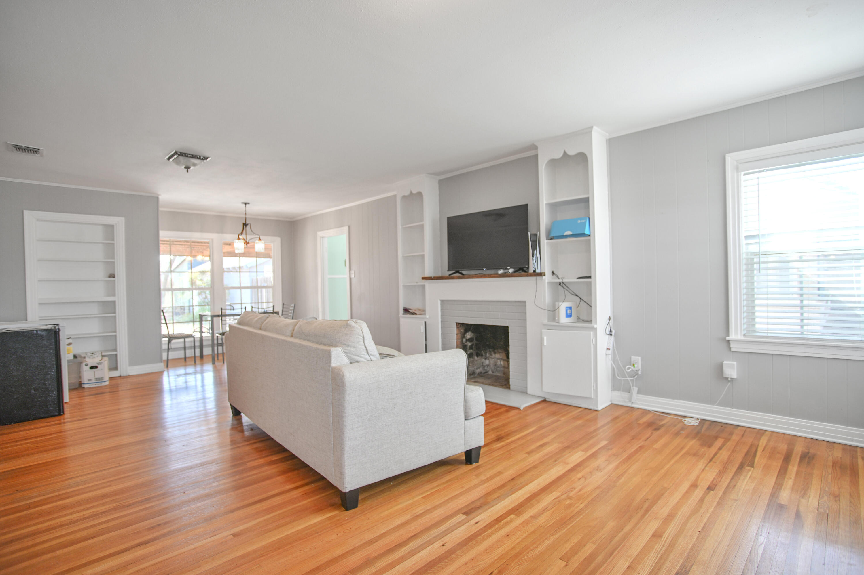3013 28th Street Lubbock, TX 79410 - Photo 4 of 38 a living room with furniture a fireplace and a flat screen tv