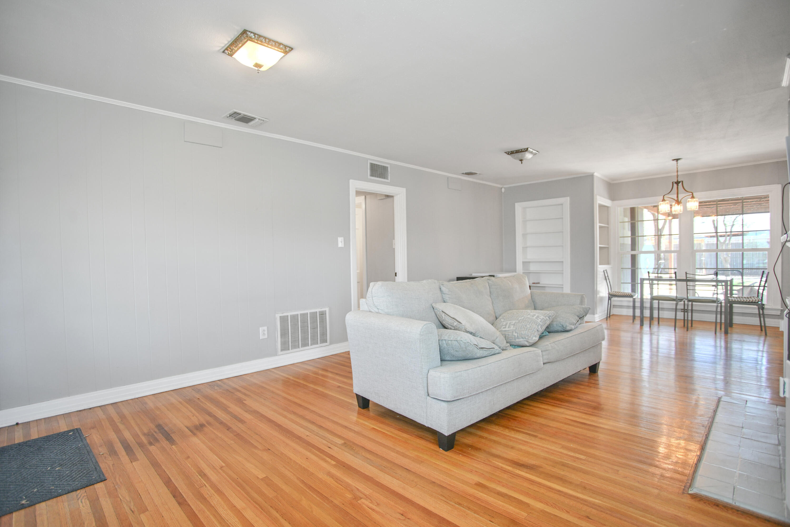 3013 28th Street Lubbock, TX 79410 - Photo 5 of 38 a living room with furniture and wooden floor