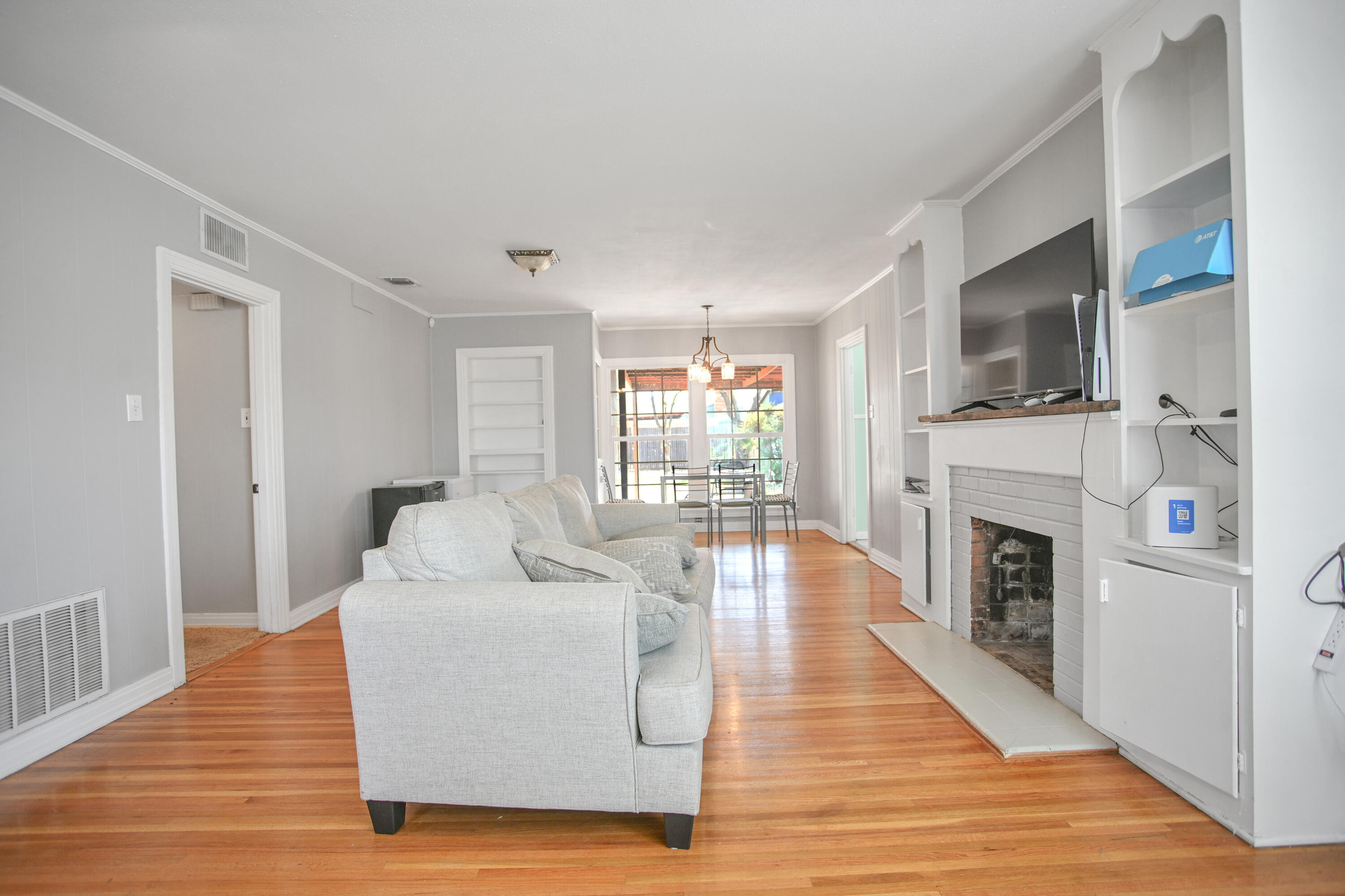 3013 28th Street Lubbock, TX 79410 - Photo 6 of 38 a living room with fireplace furniture and a wooden floor