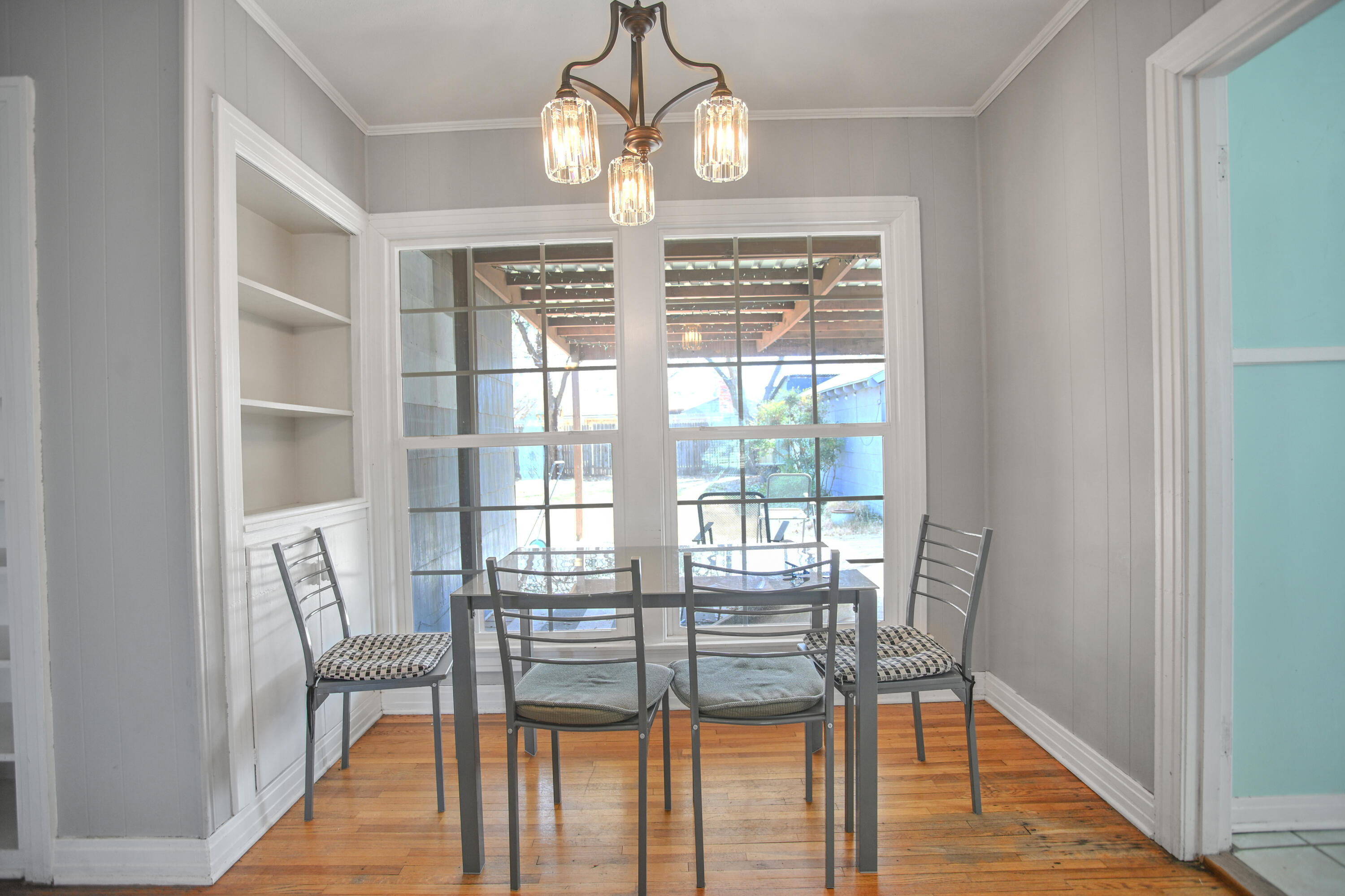 3013 28th Street Lubbock, TX 79410 - Photo 7 of 38 a view of a dining room with furniture wooden floor and chandelier