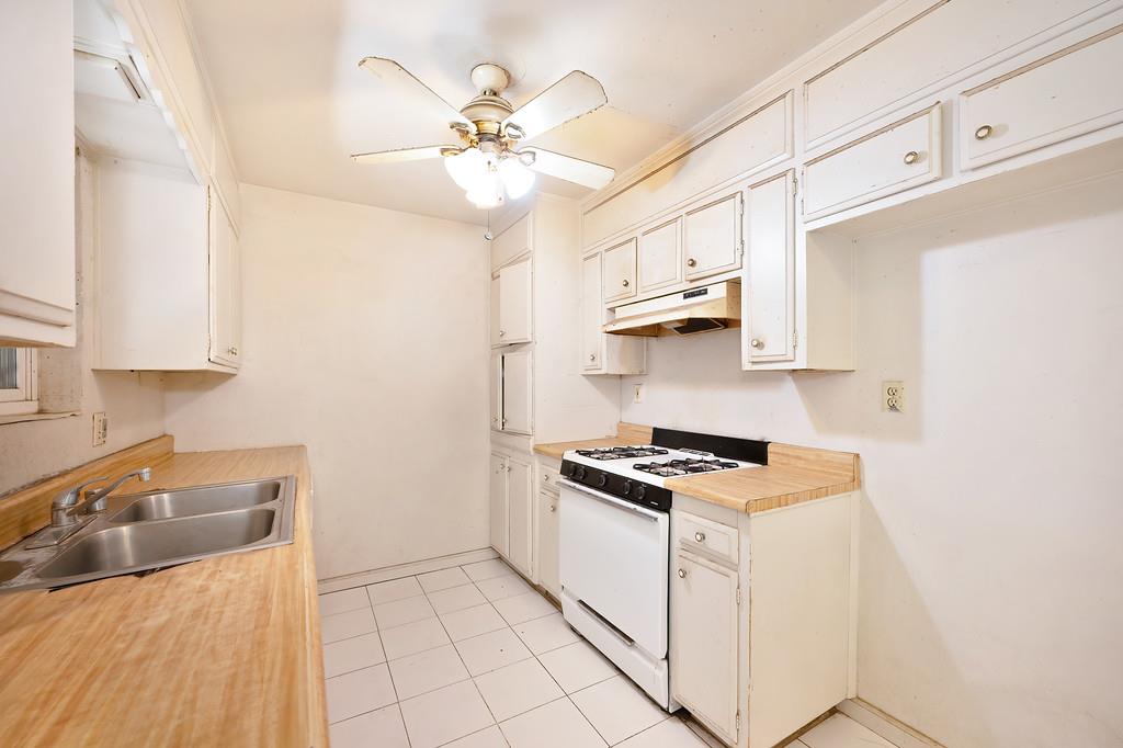 7580 Bellini Way Sacramento, CA 95828 - Photo 17 of 34 a kitchen with stainless steel appliances granite countertop a sink a stove and cabinets