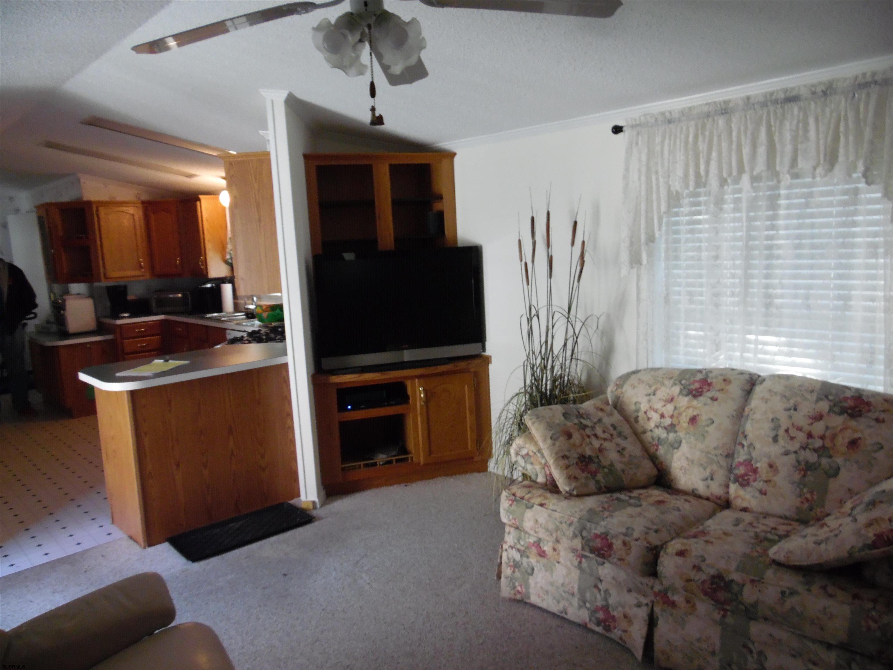 82 Elm Street Absecon, NJ 08205 - Photo 18 of 19 a living room with furniture a flat screen tv and a window