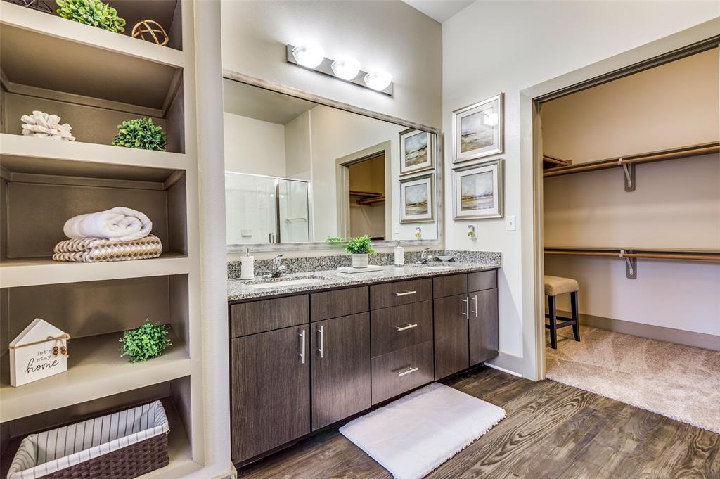 a spacious bathroom with a sink mirror and vanity