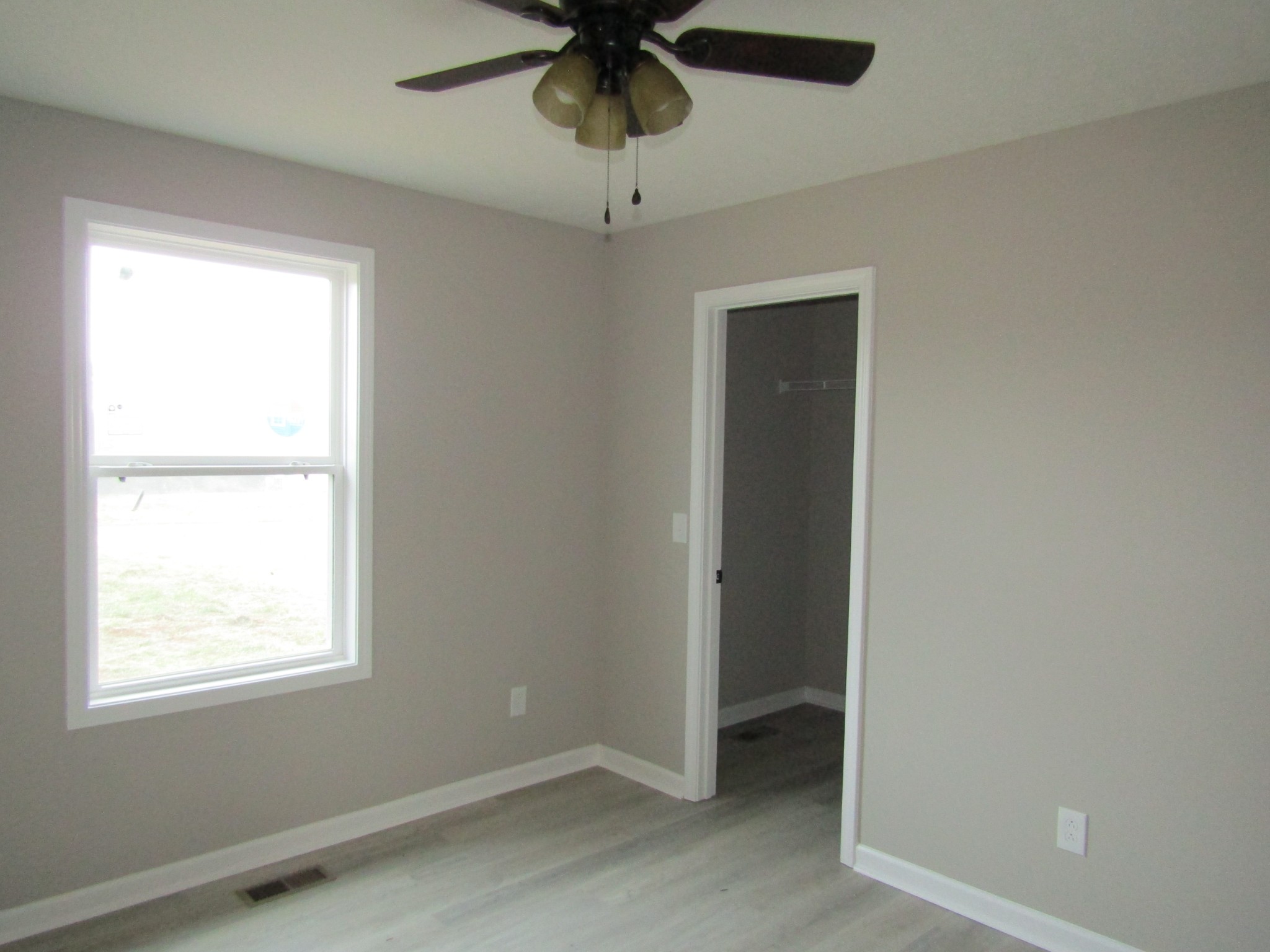 2337 Claude Fox Road Cornersville, TN 37047 - Photo 13 of 14 an empty room with a window and a ceiling fan