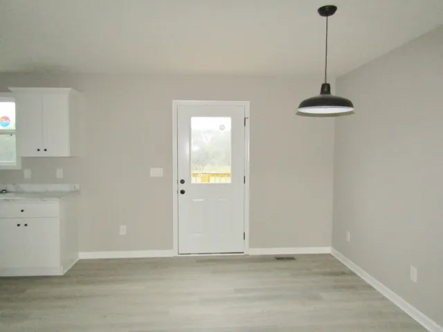 a very nice looking room with a chandelier fan