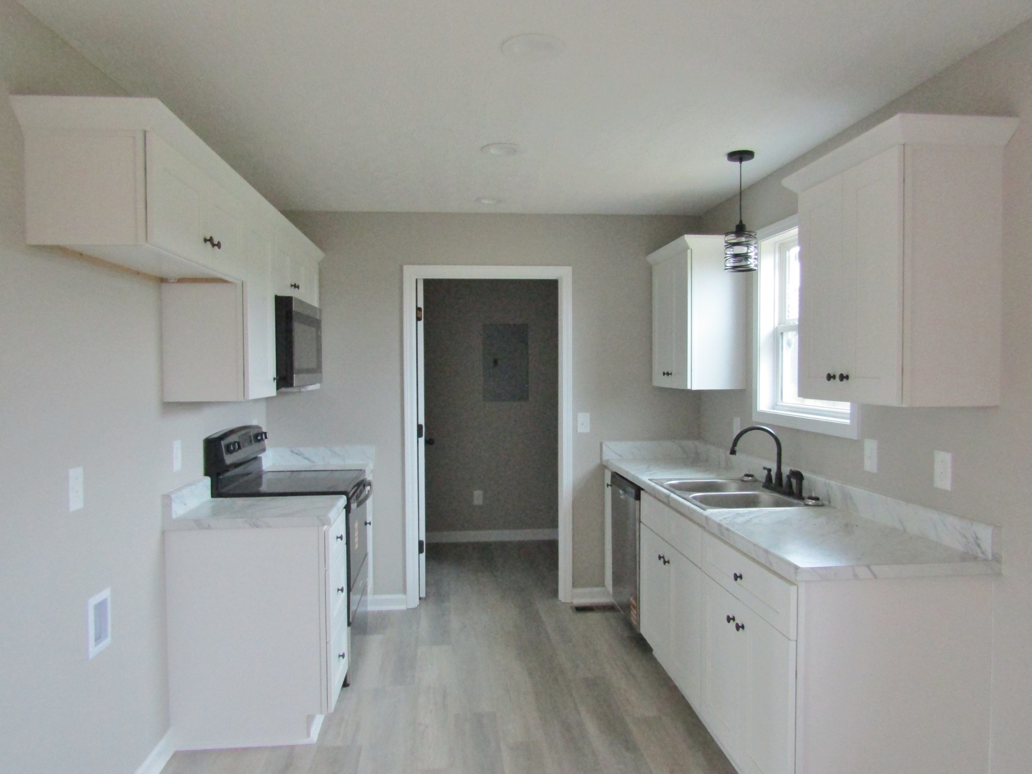 2337 Claude Fox Road Cornersville, TN 37047 - Photo 6 of 14 a kitchen with a sink a stove and cabinets