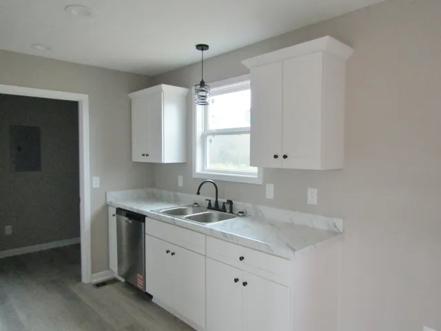 a kitchen with sink stove and cabinets