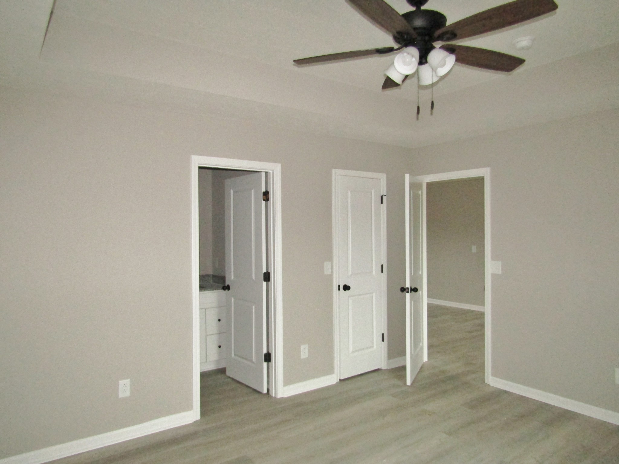 2337 Claude Fox Road Cornersville, TN 37047 - Photo 10 of 14 a view of a hallway with a chandelier fan and wooden floor