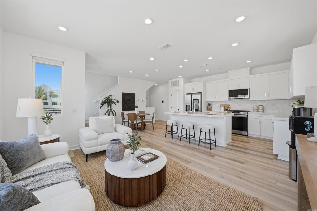2402 Cascalote Loop San Diego, CA 92154 - Photo 8 of 35 a living room with furniture kitchen and a wooden floor