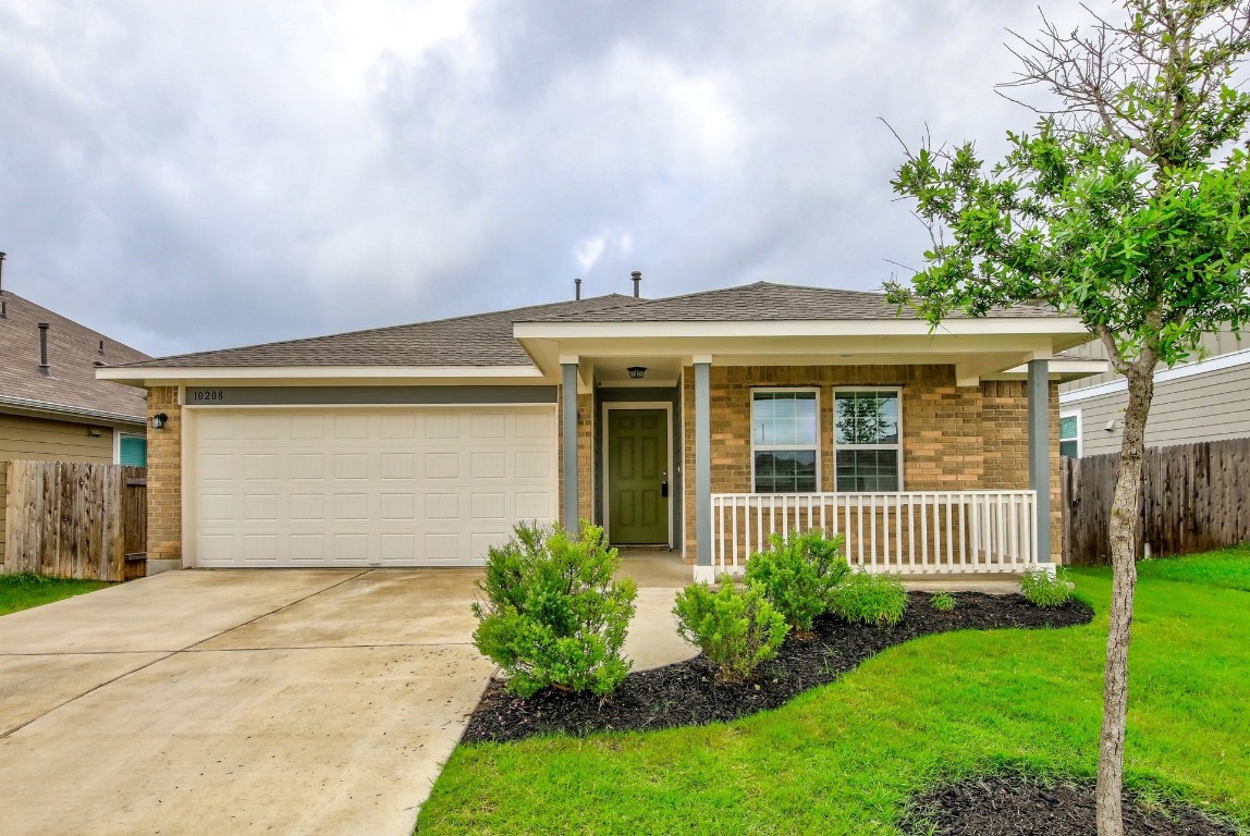 10208 Bankhead Drive Austin, TX 78747 - Photo 1 of 1 a front view of a house with a garden