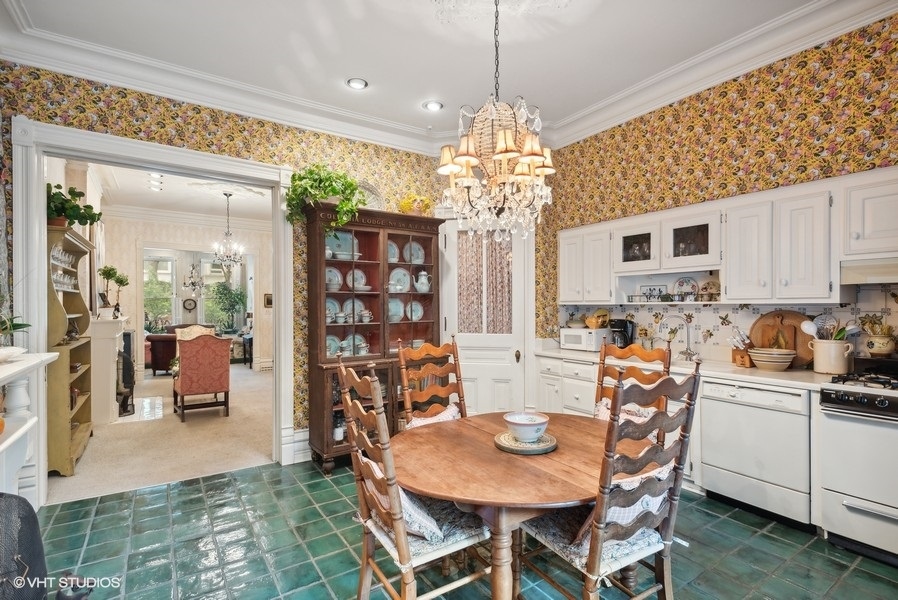 59 East Elm Street Chicago, IL 60611 - Photo 12 of 27 a view of a dining room with furniture a chandelier and wooden floor