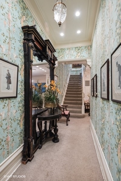 59 East Elm Street Chicago, IL 60611 - Photo 2 of 27 a view of a hallway with stairs and a chandelier