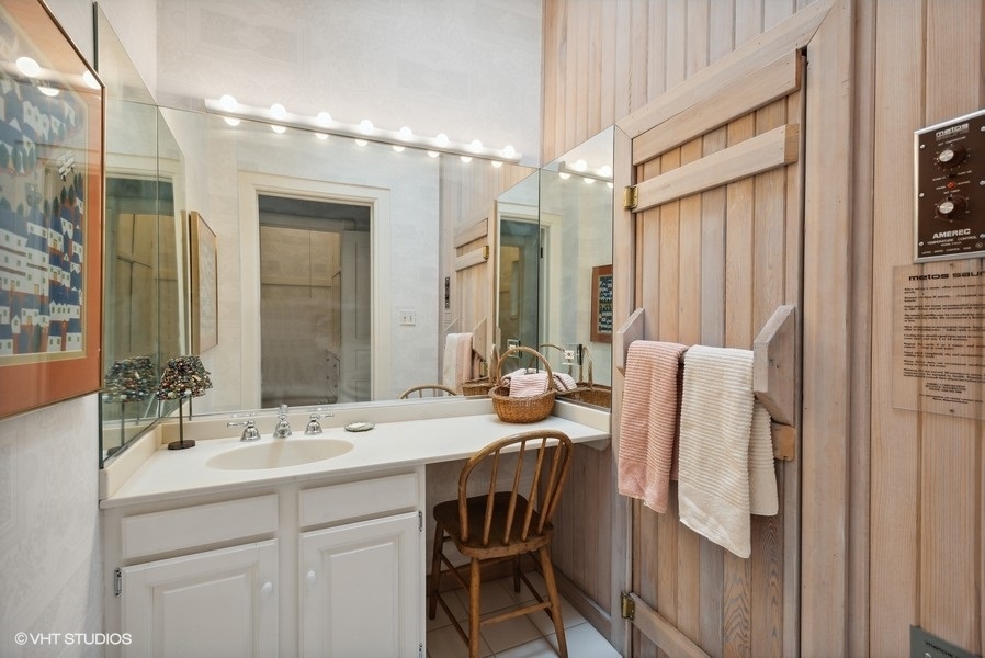 59 East Elm Street Chicago, IL 60611 - Photo 23 of 27 a bathroom with a sink a mirror and a shower