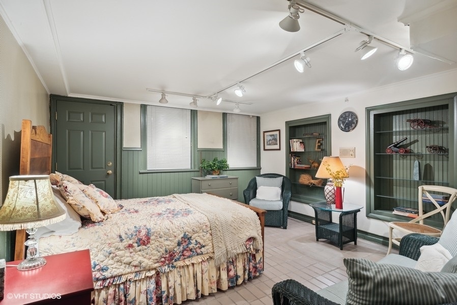 59 East Elm Street Chicago, IL 60611 - Photo 25 of 27 a bedroom with a bed mirror table and chair