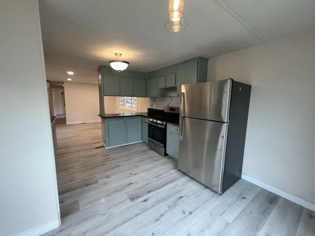 a kitchen with a refrigerator and a sink