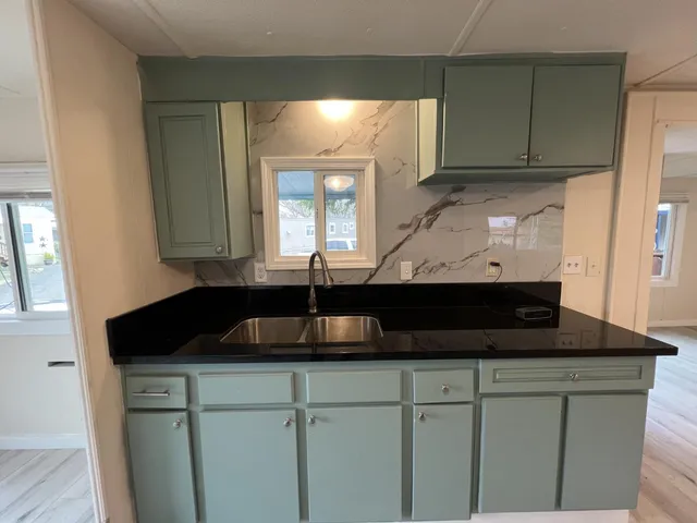 a kitchen with a sink and cabinets