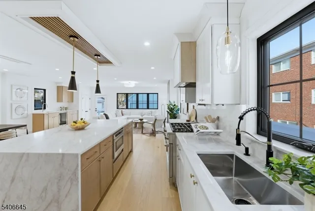 a kitchen with sink stove and cabinets