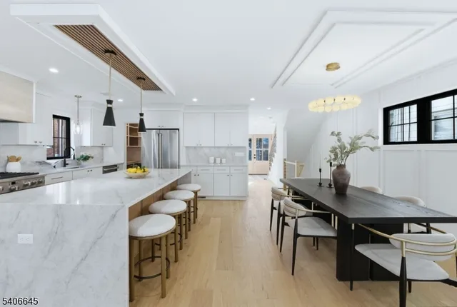 a large kitchen with a table and chairs