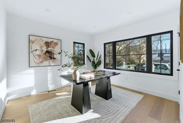 a view of a workspace with furniture and window