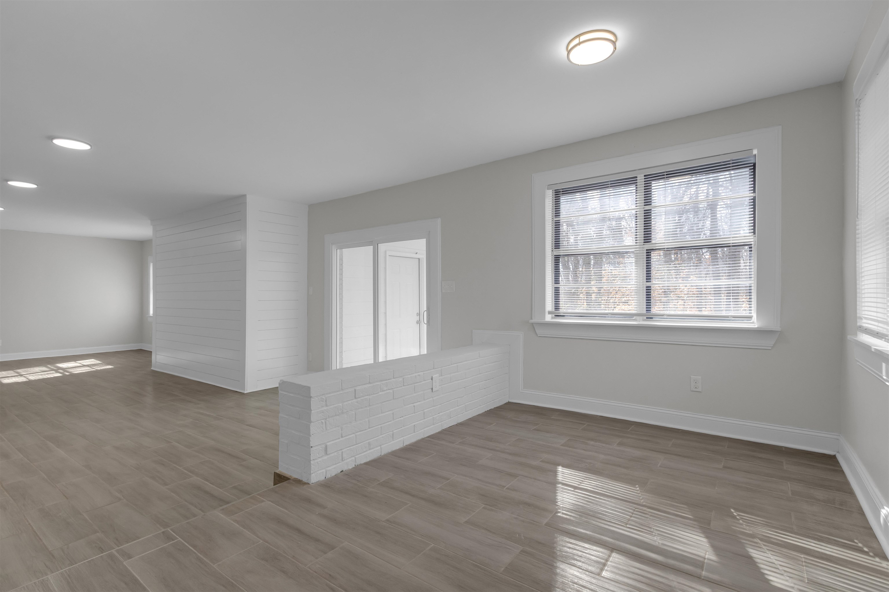 1296 Monasco Road Millington, TN 38053 - Photo 9 of 32 wooden floor in an empty room with a window