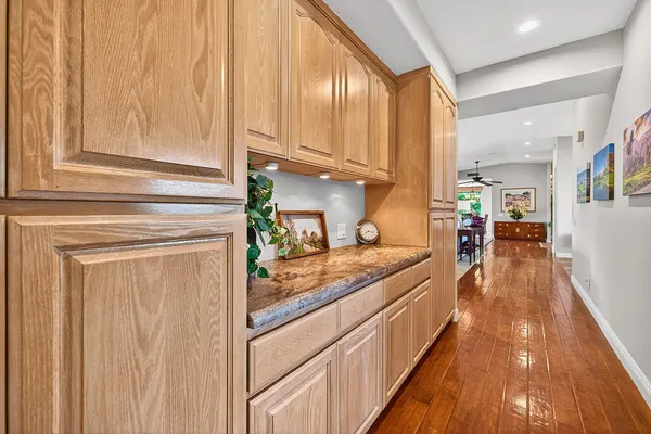 a kitchen with stainless steel appliances granite countertop a lot of counter space and wooden floor
