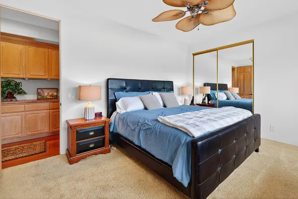 a bedroom with a bed and a chandelier