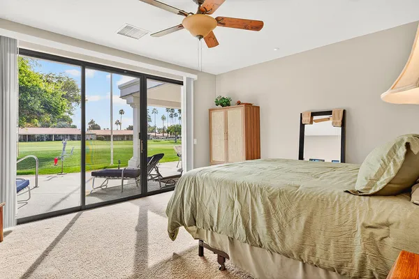 a bedroom with a bed and a balcony