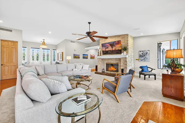 a living room with furniture a fireplace and a flat screen tv