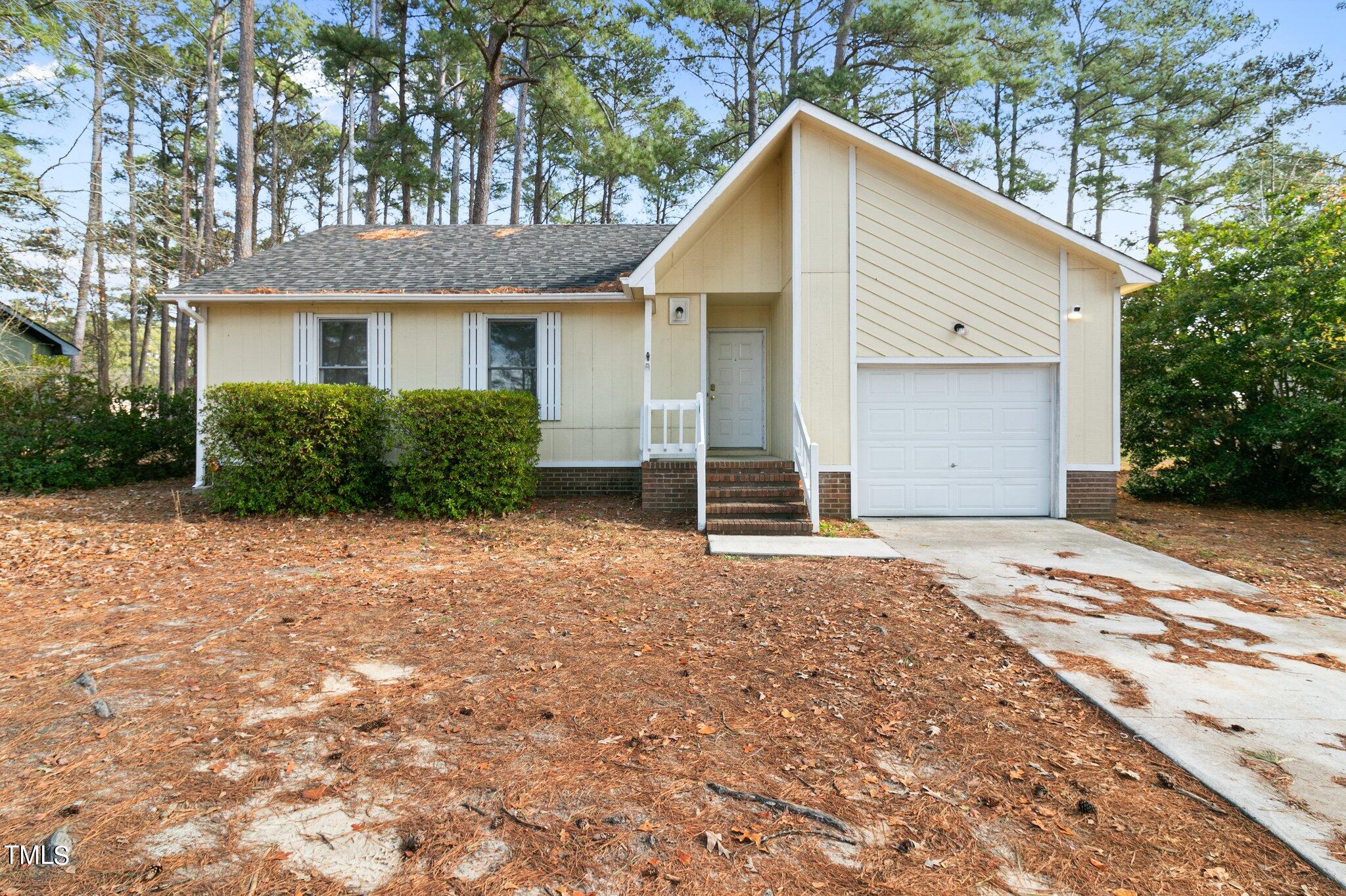 1775 Rim Road Fayetteville, NC 28314 - Photo 1 of 16 a front view of a house with garden
