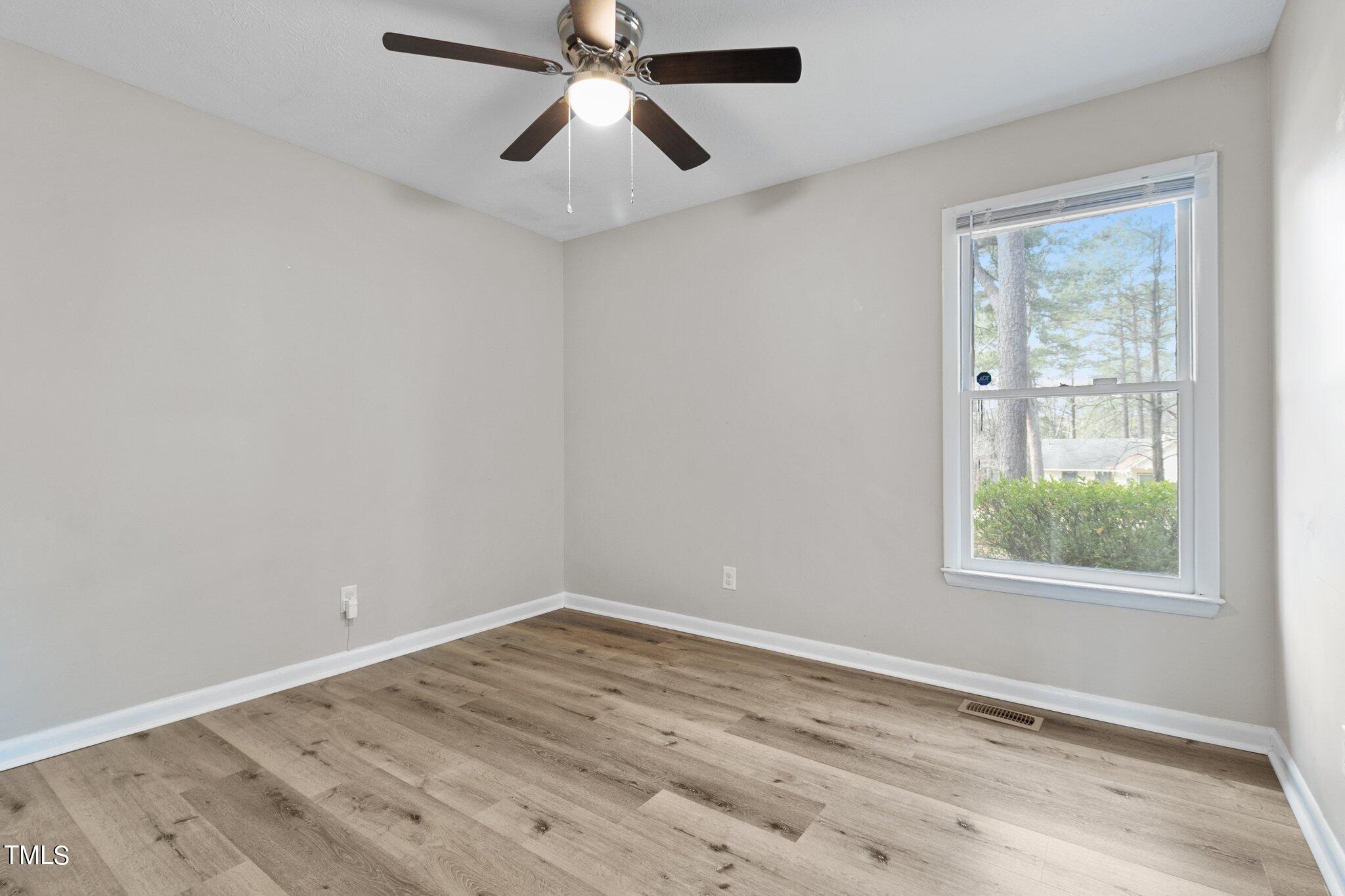 1775 Rim Road Fayetteville, NC 28314 - Photo 11 of 16 wooden floor in an empty room with a window