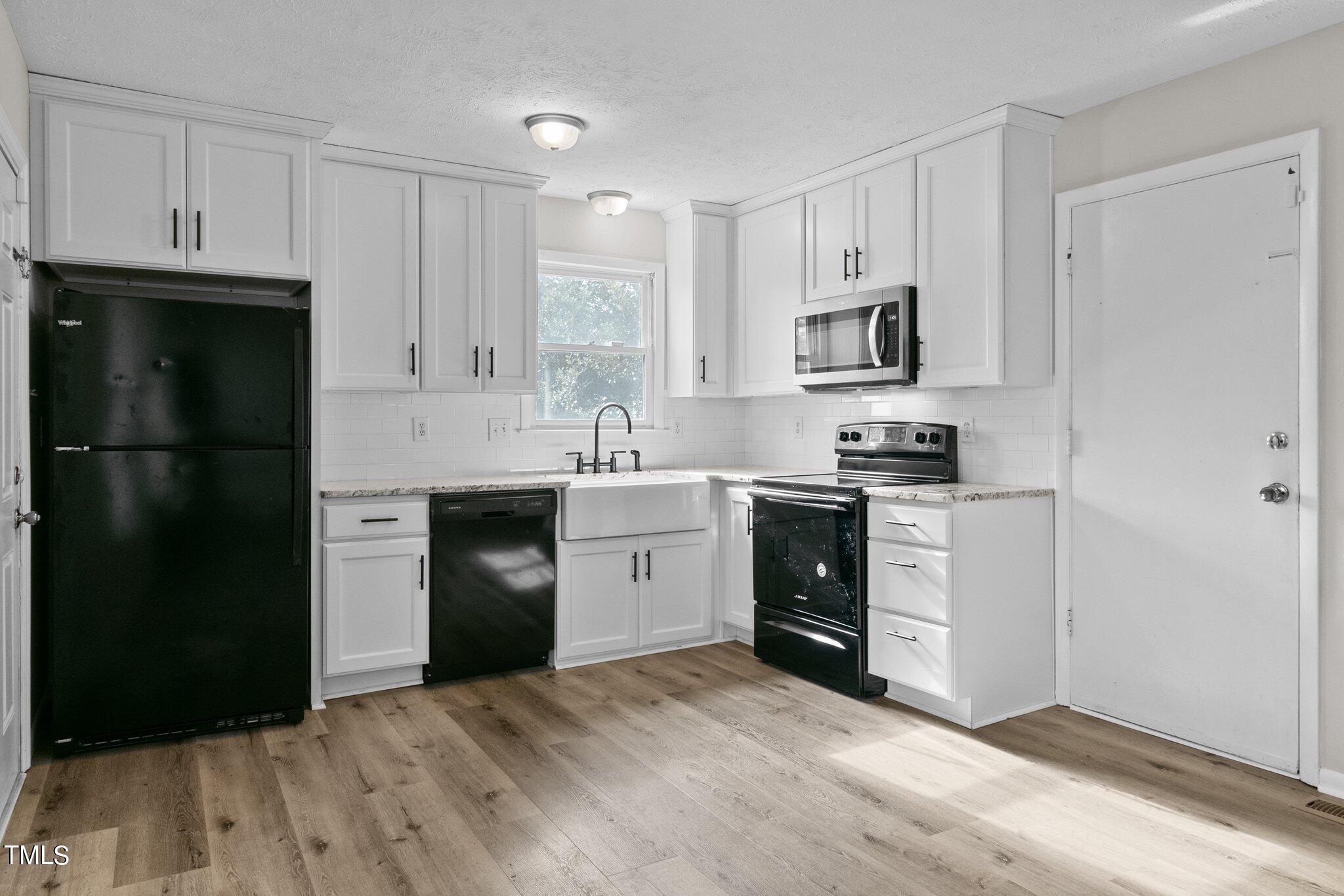 1775 Rim Road Fayetteville, NC 28314 - Photo 4 of 16 a kitchen with a refrigerator stove and sink