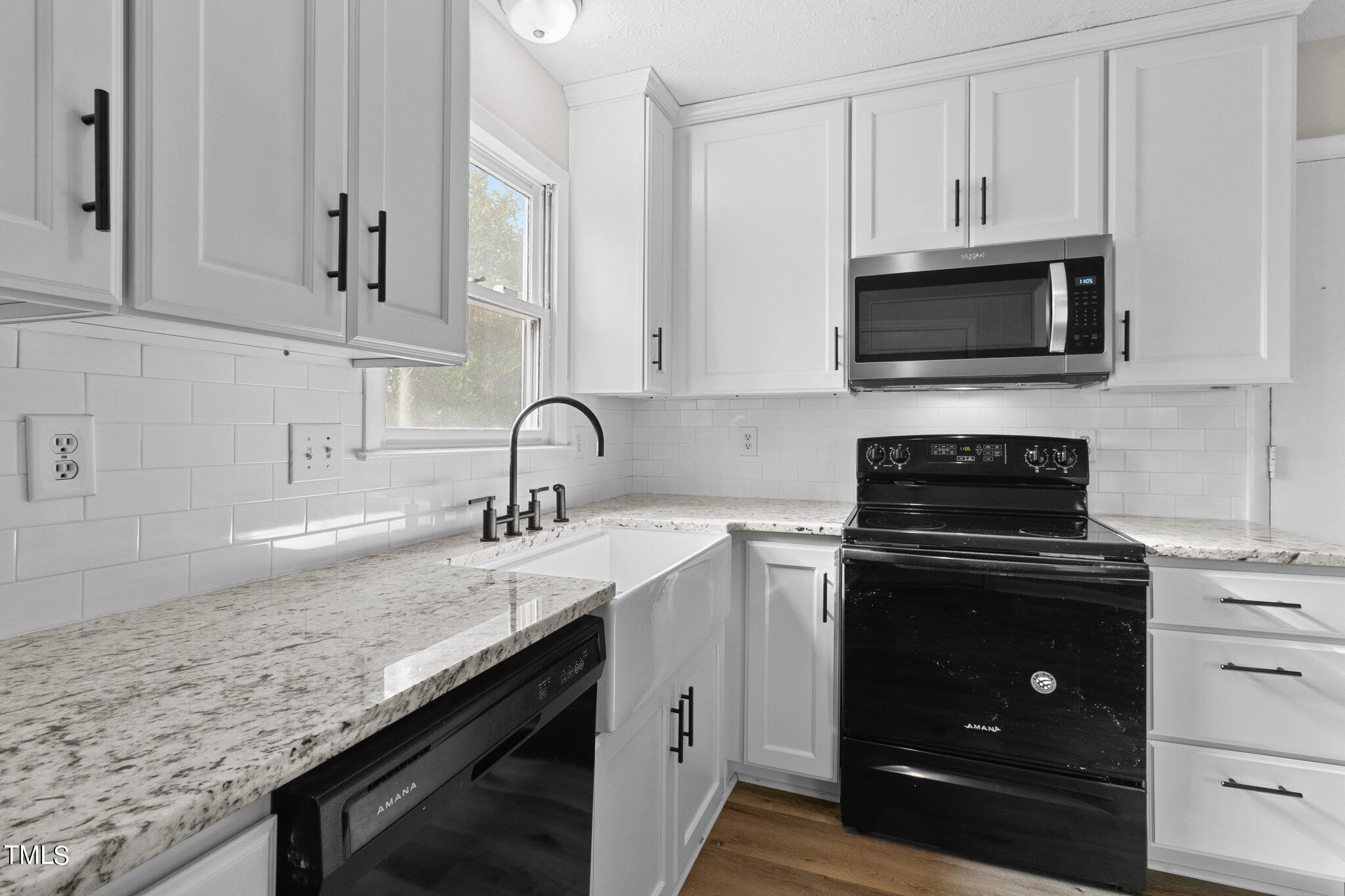 1775 Rim Road Fayetteville, NC 28314 - Photo 5 of 16 a kitchen with granite countertop white cabinets and a sink