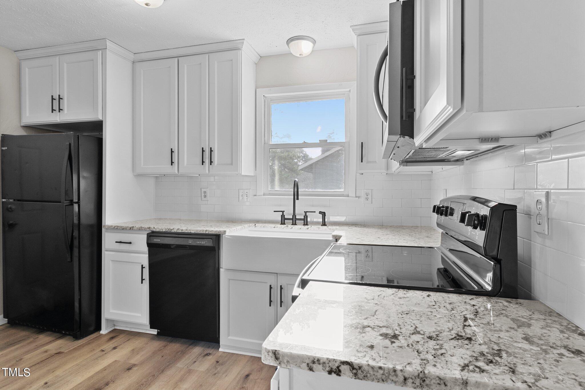 1775 Rim Road Fayetteville, NC 28314 - Photo 6 of 16 a kitchen with stainless steel appliances kitchen island sink refrigerator and stove