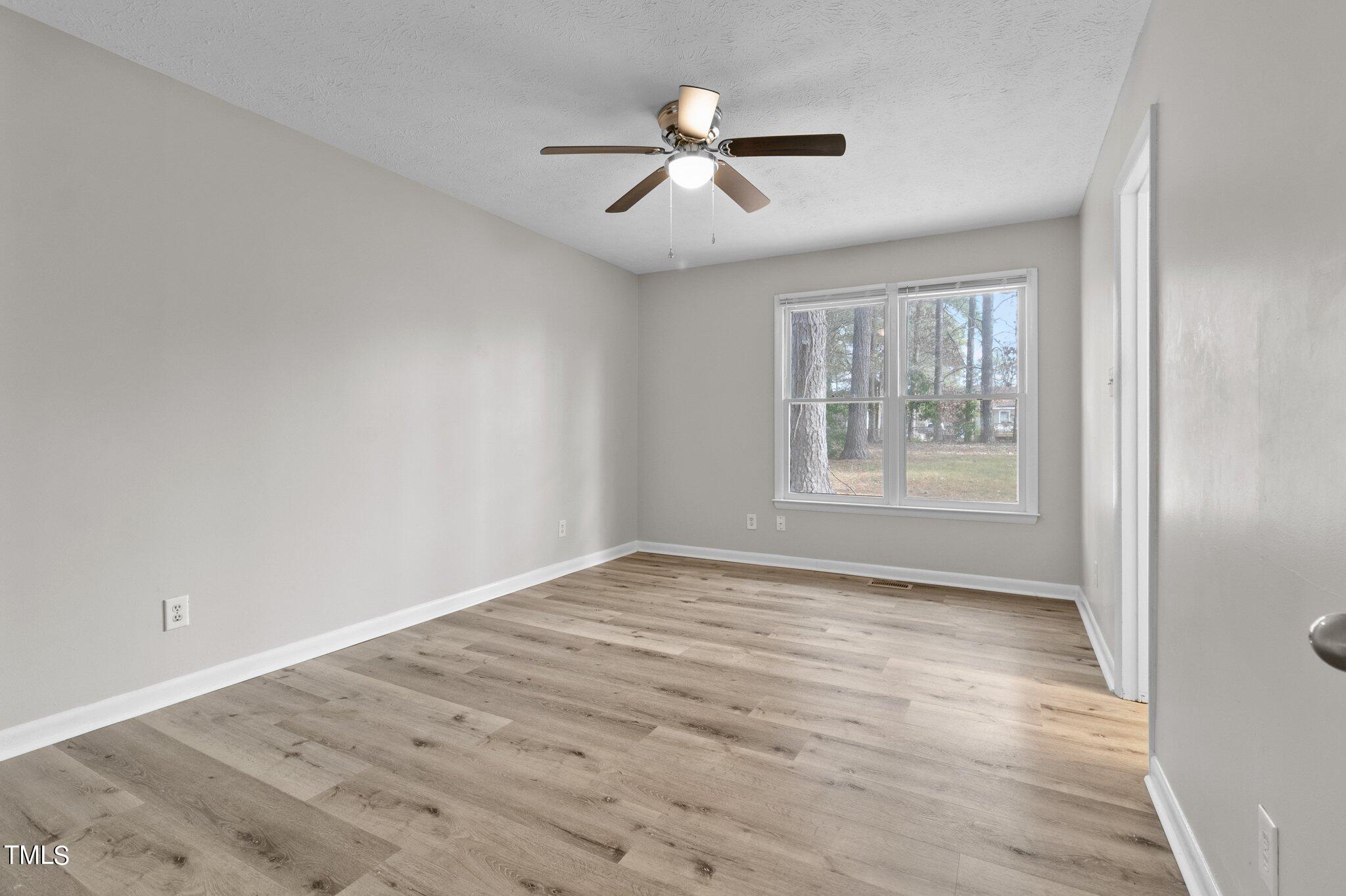 1775 Rim Road Fayetteville, NC 28314 - Photo 9 of 16 wooden floor in an empty room with a window