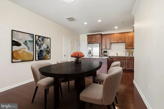 a kitchen with stainless steel appliances granite countertop a refrigerator a sink a stove a microwave and wooden cabinets