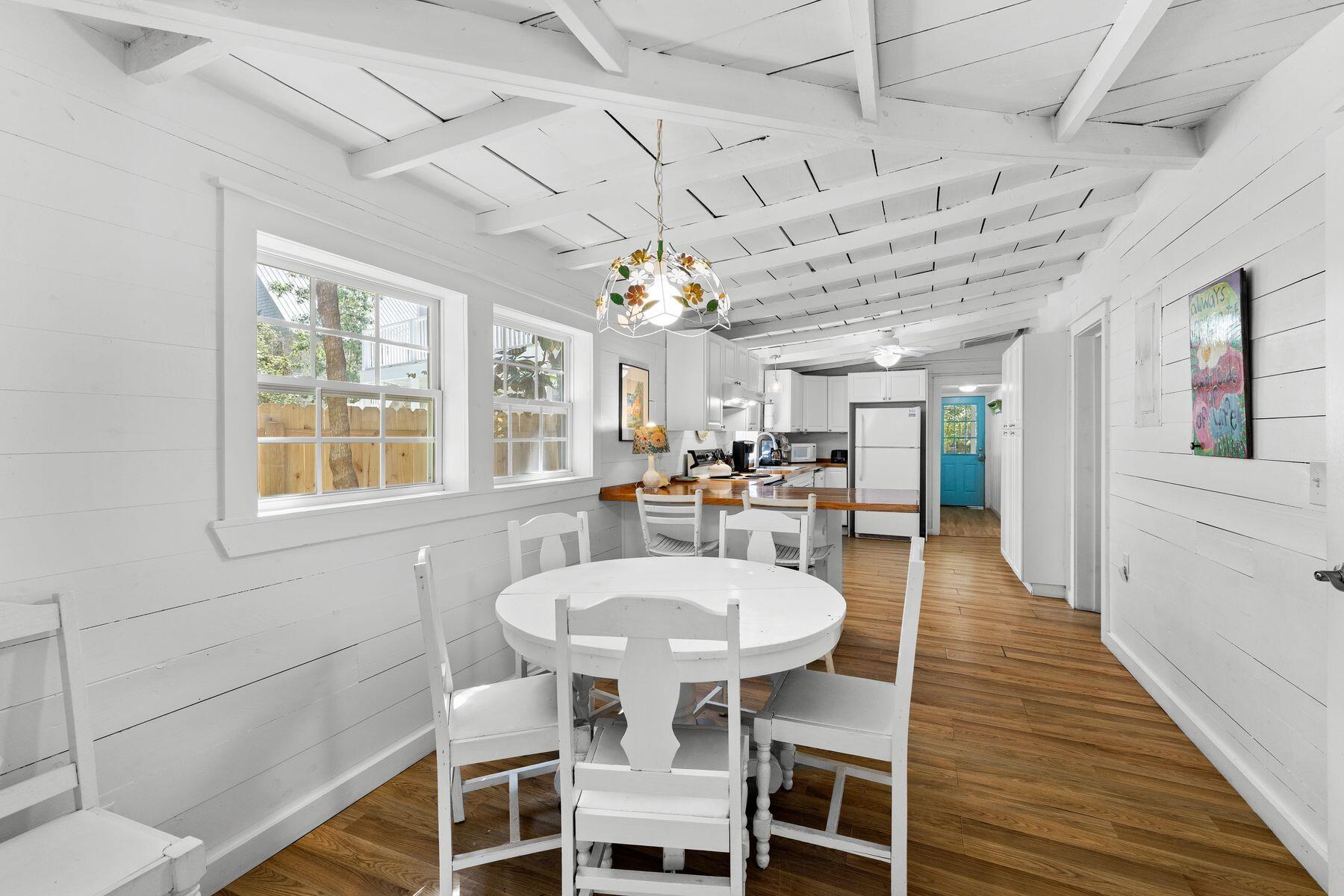 147 Magnolia Street Santa Rosa Beach, FL 32459 - Photo 13 of 33 a view of a dining room with furniture window and wooden floor
