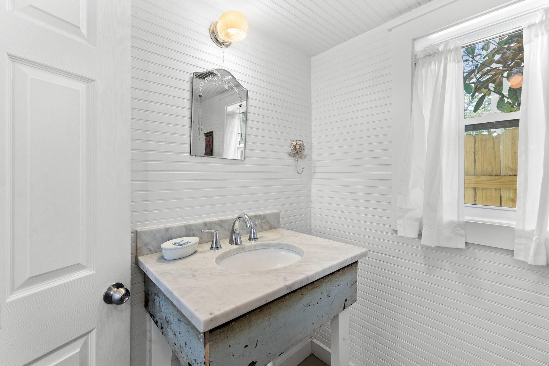 147 Magnolia Street Santa Rosa Beach, FL 32459 - Photo 16 of 33 a bathroom with a sink and a mirror