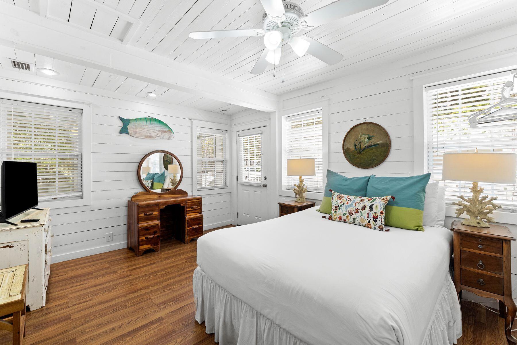 147 Magnolia Street Santa Rosa Beach, FL 32459 - Photo 17 of 33 a bedroom with a bed and wooden floor