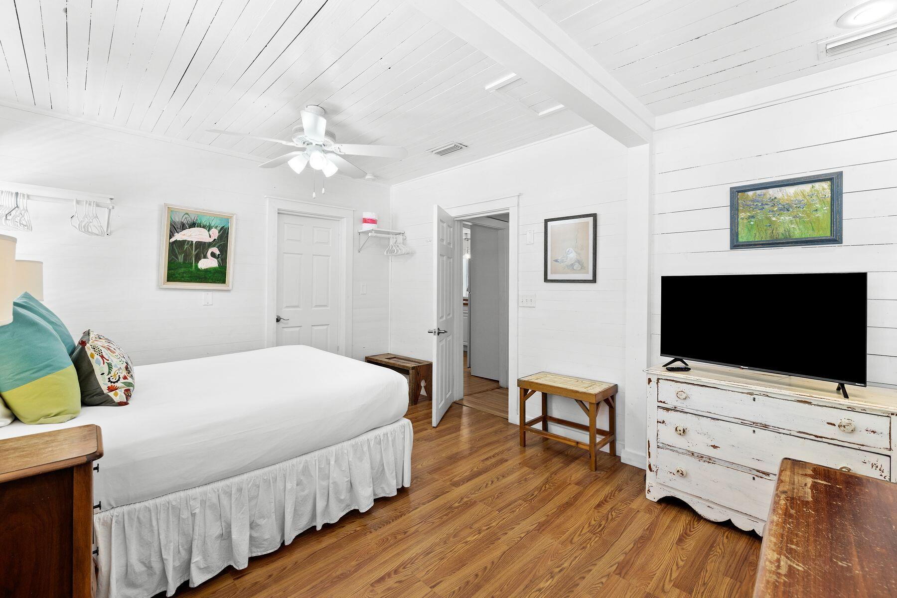 147 Magnolia Street Santa Rosa Beach, FL 32459 - Photo 18 of 33 a bedroom with a bed and a flat screen tv