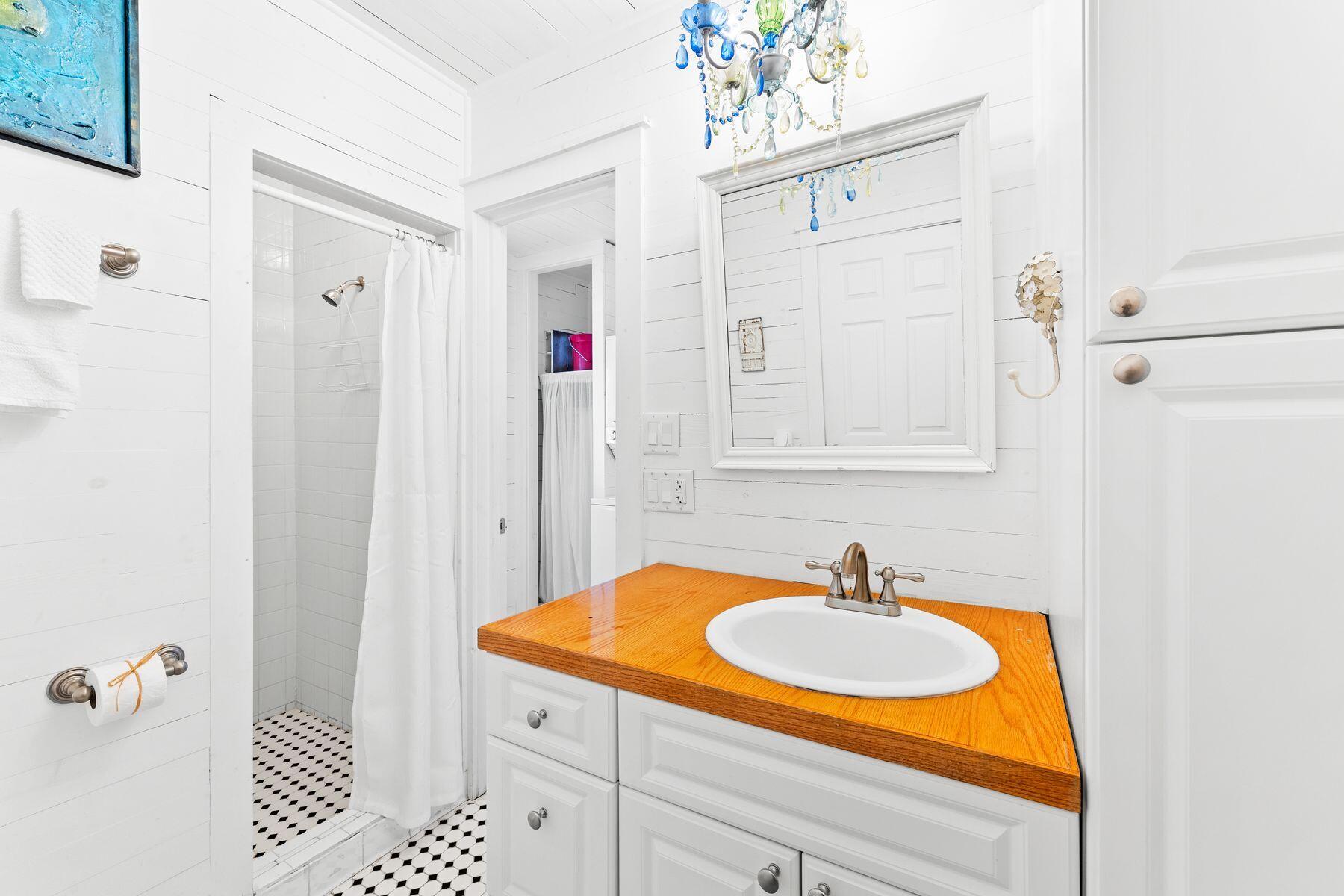 147 Magnolia Street Santa Rosa Beach, FL 32459 - Photo 20 of 33 a bathroom with a sink and a mirror