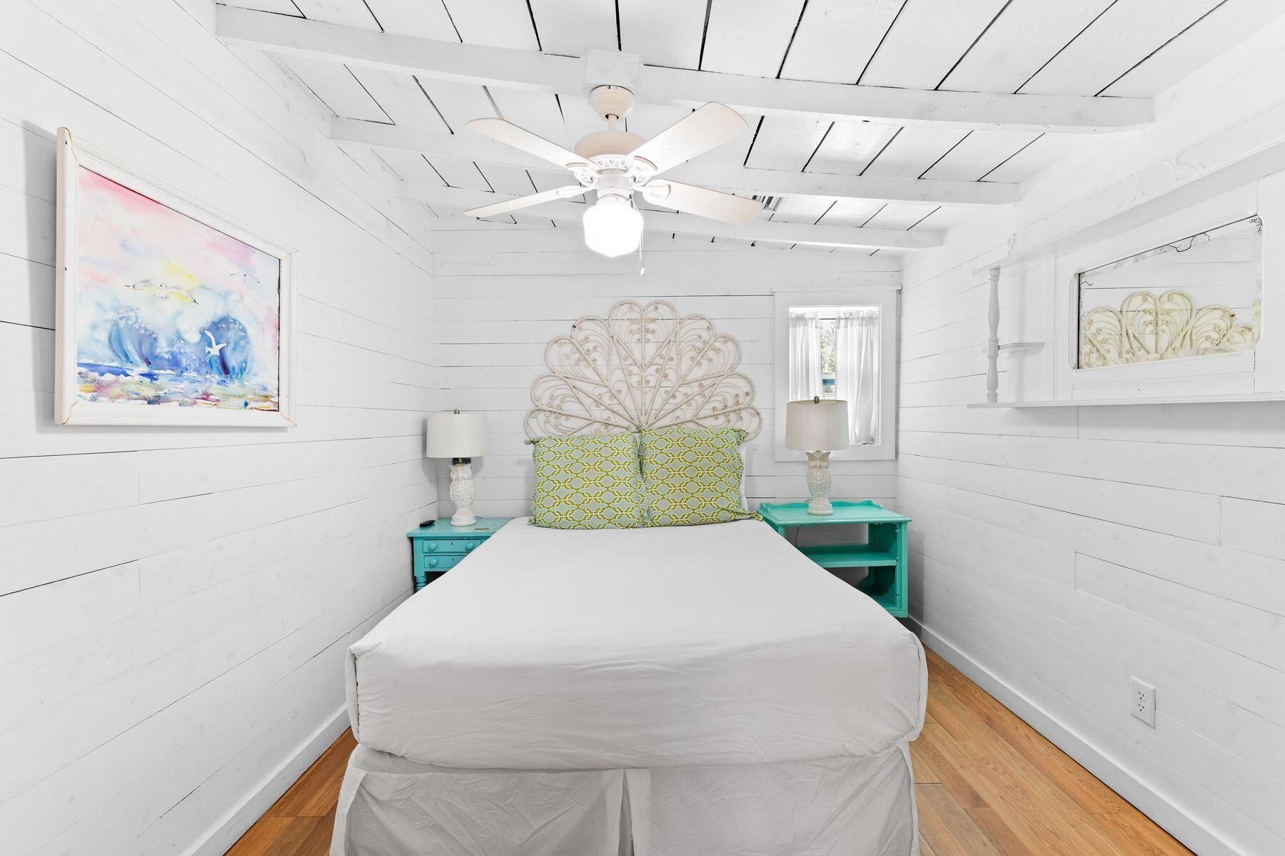 147 Magnolia Street Santa Rosa Beach, FL 32459 - Photo 22 of 33 a bedroom with a large bed and a chandelier
