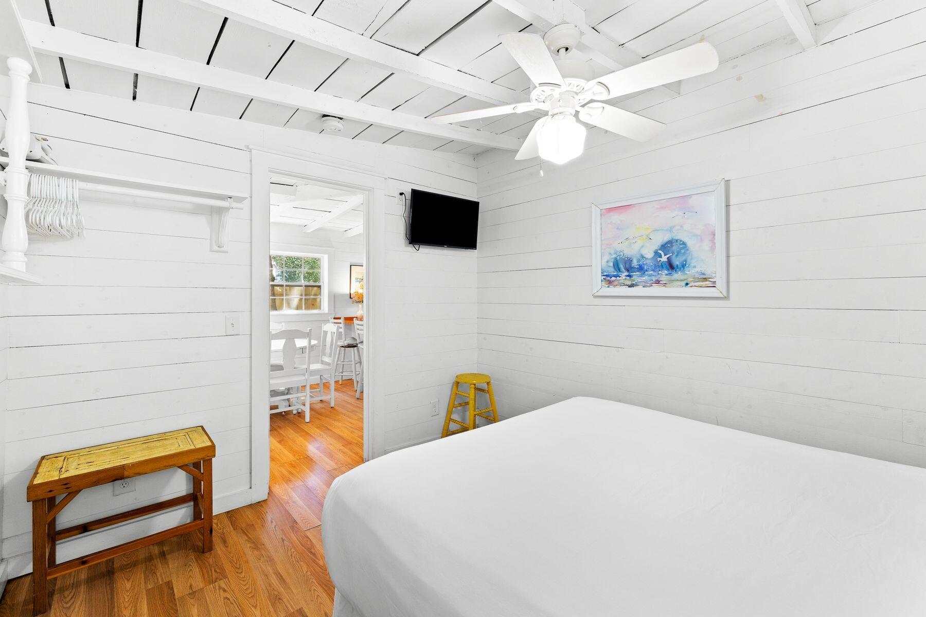 147 Magnolia Street Santa Rosa Beach, FL 32459 - Photo 23 of 33 a bedroom with a bed and a chandelier