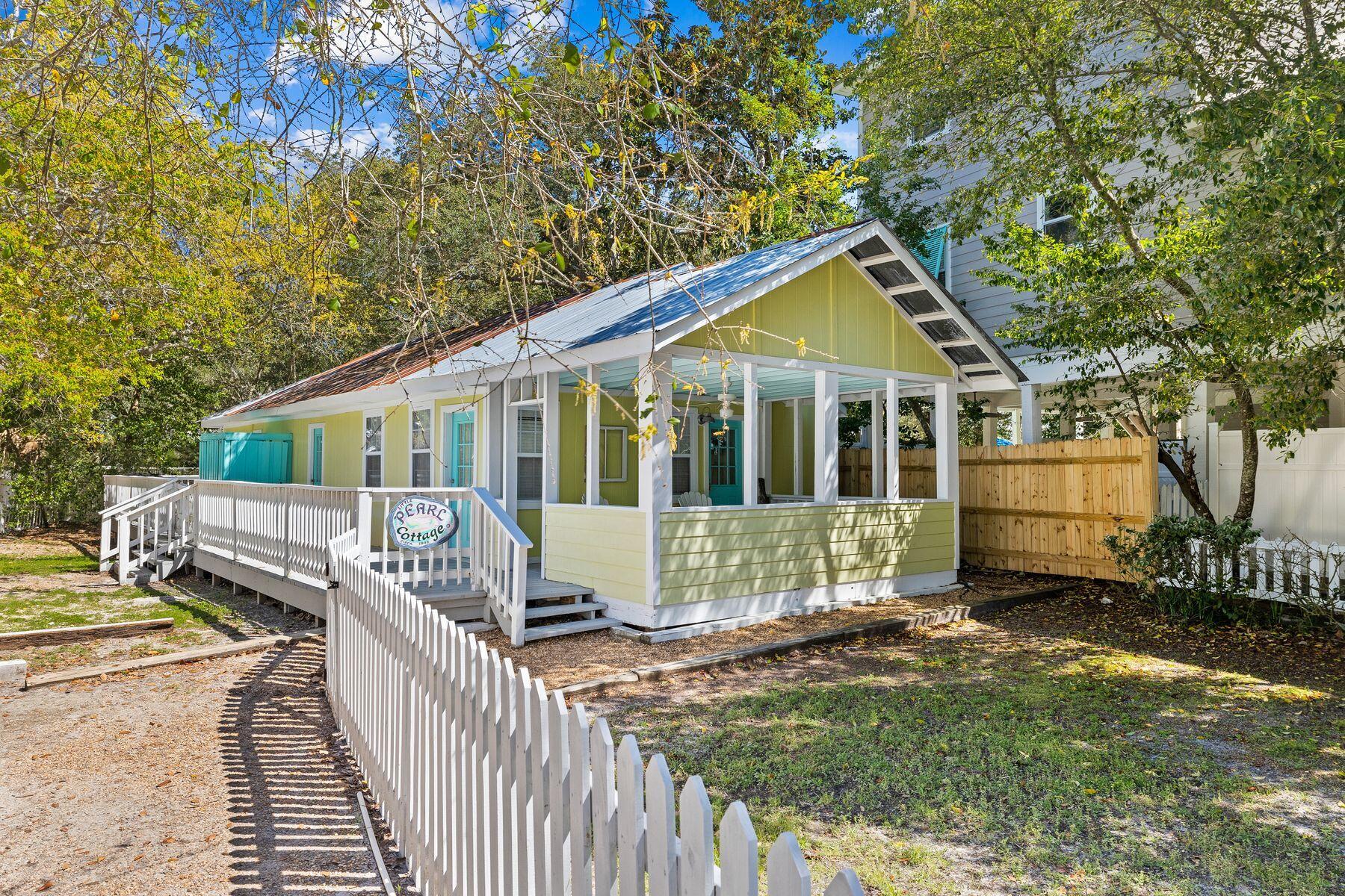 147 Magnolia Street Santa Rosa Beach, FL 32459 - Photo 3 of 33 a view of a house with a small yard and wooden fence