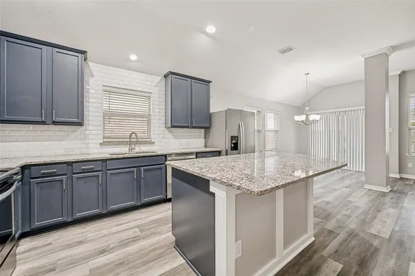 a kitchen with stainless steel appliances granite countertop wooden cabinets a sink and dishwasher
