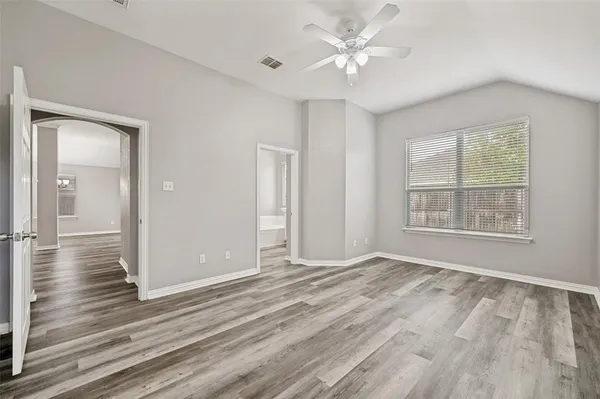 a bathroom with a double vanity sink a mirror and a bathtub