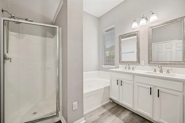 a spacious bathroom with a granite countertop sink toilet and shower