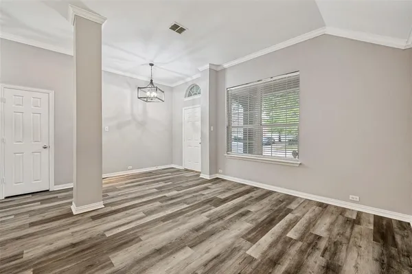 a view of a room with wooden floor and window