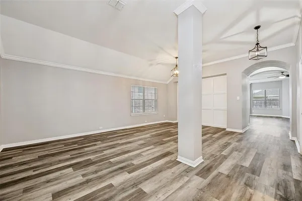 a view of a livingroom with wooden floor and a ceiling fan